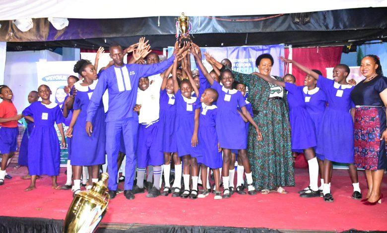 Nakivubo Primary School celebrates with their headteacher and the Director Education and Social Services KCCA on the extreme right.