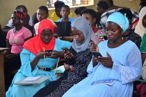 Hadijjah Nanteza (in blue veil) attends a mobile video editing class as part of thedigital skills training under UCUSAF and Prime Time Communications in Lwengo District. June 7, 2024.